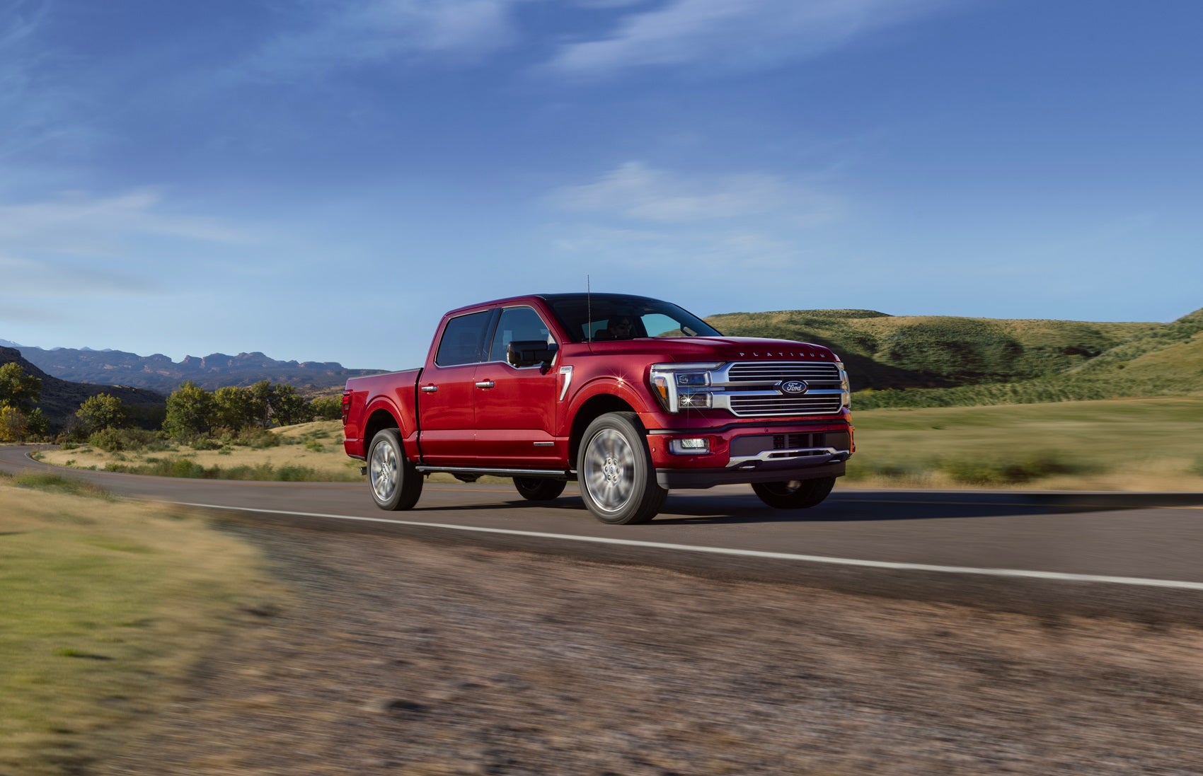 Ford F-150 Platinum driving through countryside with motion blur