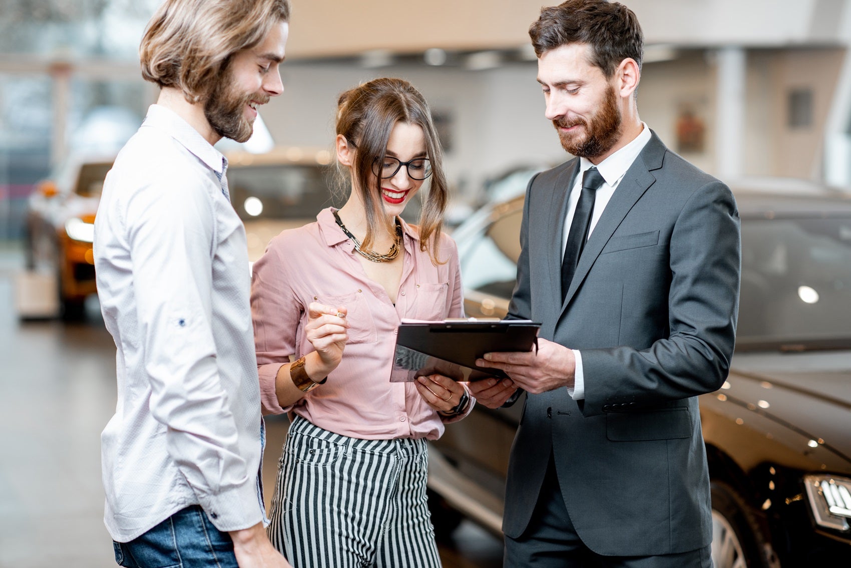 Couple reviewing financial paperwork with Ford Finance Team member