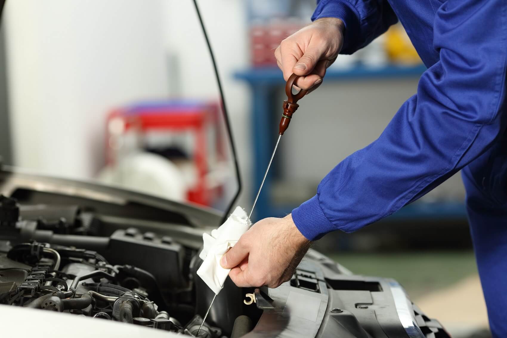 Service Technician Checking the Oil of a Used Vehicle