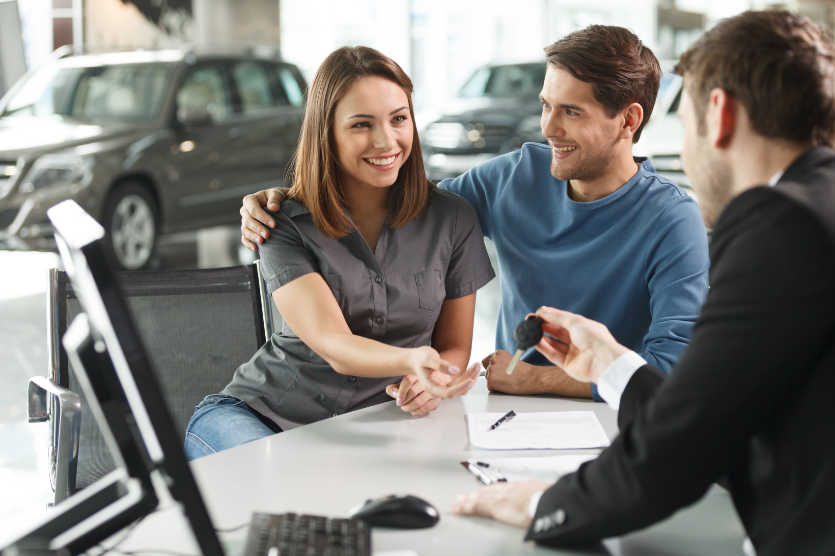 Ford Team member handing keys to couple for their new Ford vehicle