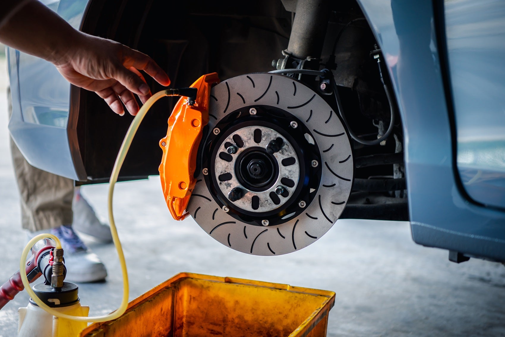 Ford Certified Technician repairing a brake at the Service Center