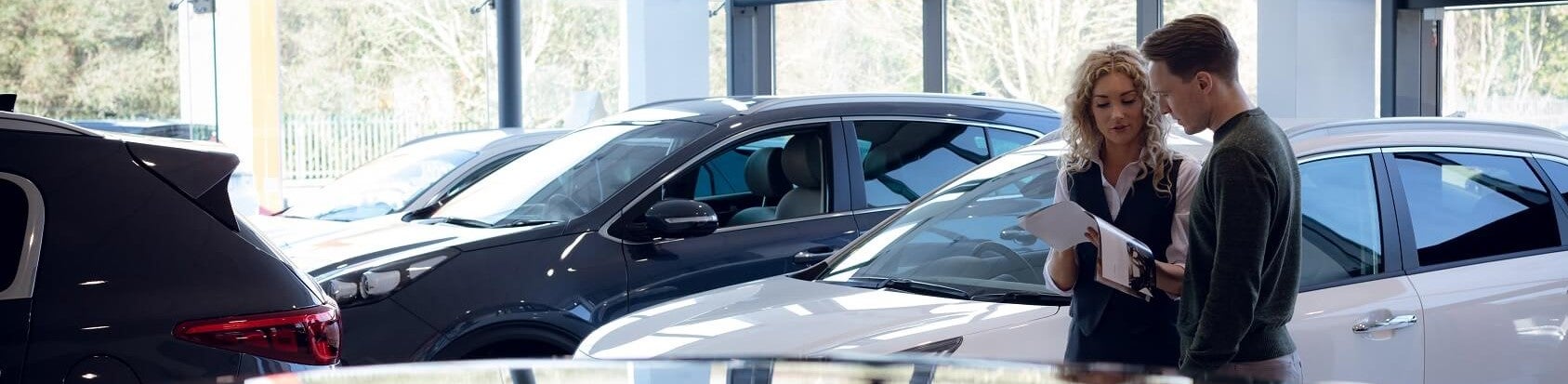 Ford Team member showing customer used vehicle options at Used Car Dealer near Me