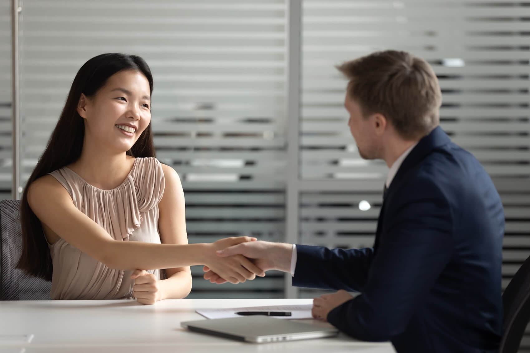 Ford Finance team member shaking hands with customer after discussing financing options at Used Car Dealer near Me