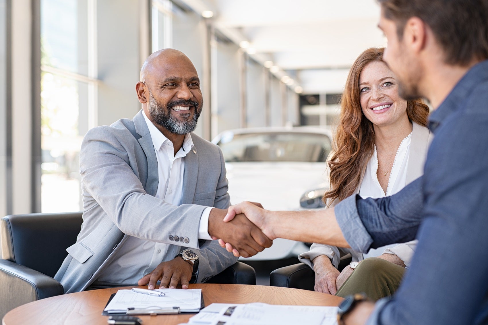 Ford Team Member shaking hands with customer while discussing Ford options